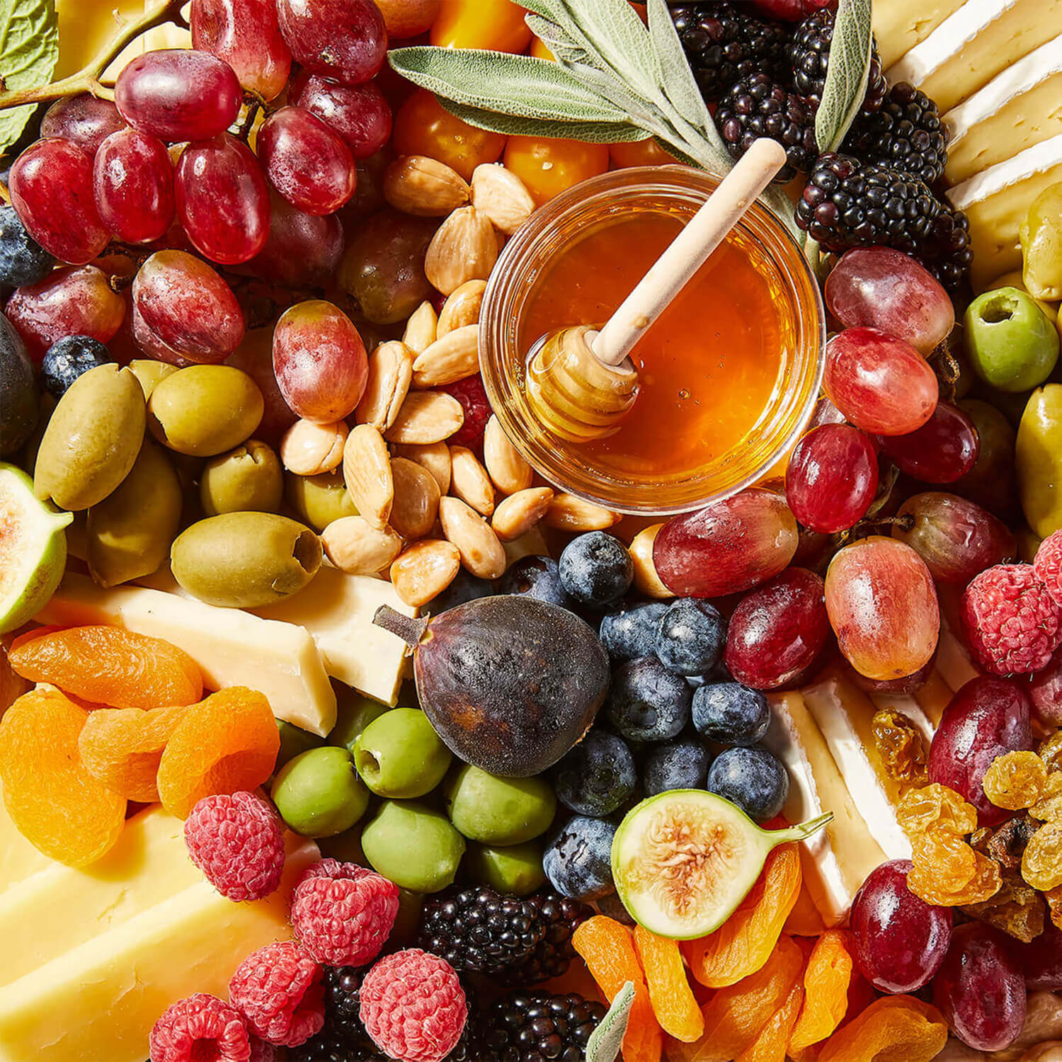Close-up of a Grazy board containing cheeses and fruits