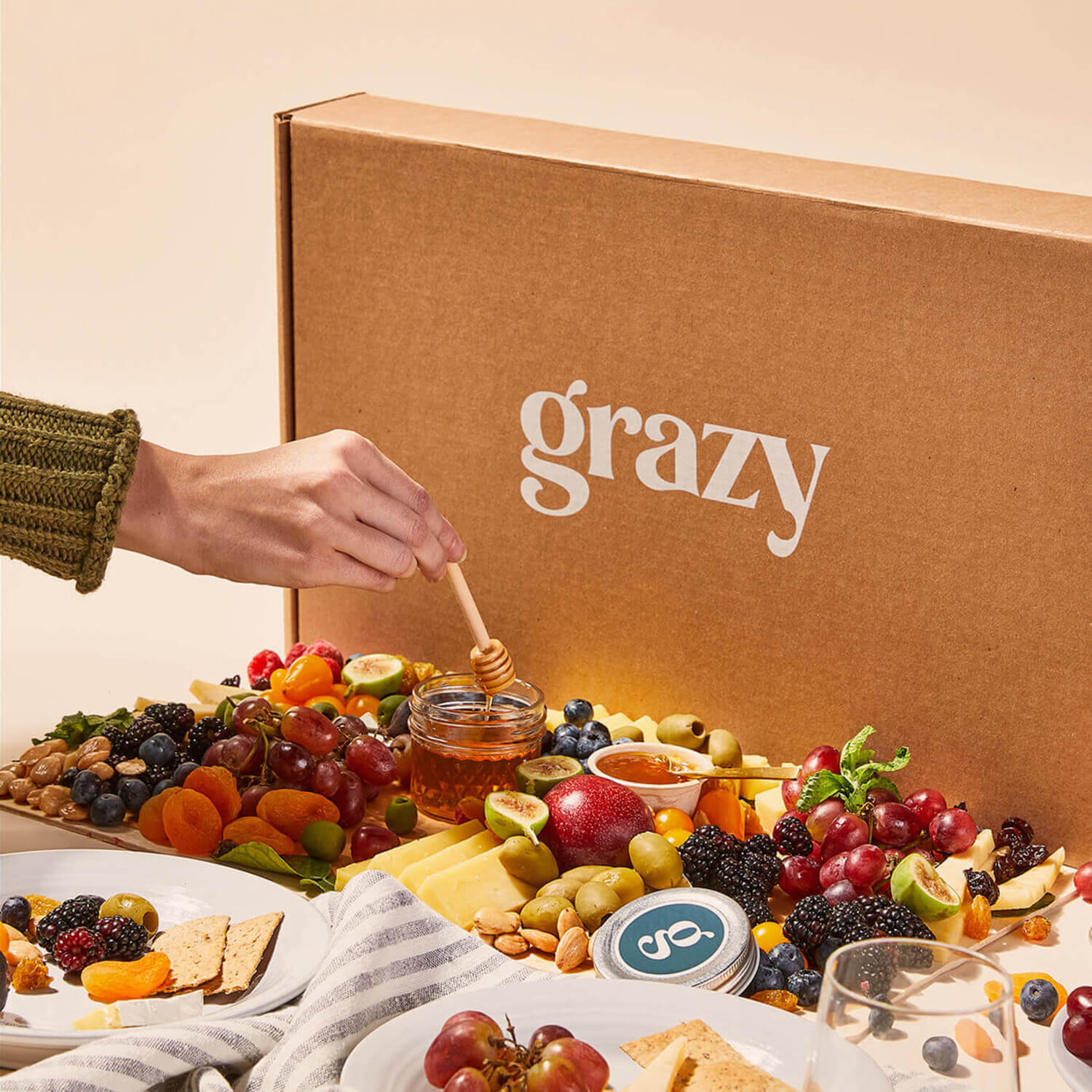 Angled view of a large Grazy box containing cheeses and fruits