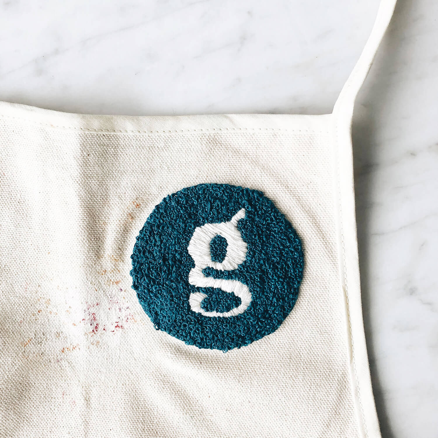 Close-up shot of a hand embroidered Grazy apron
