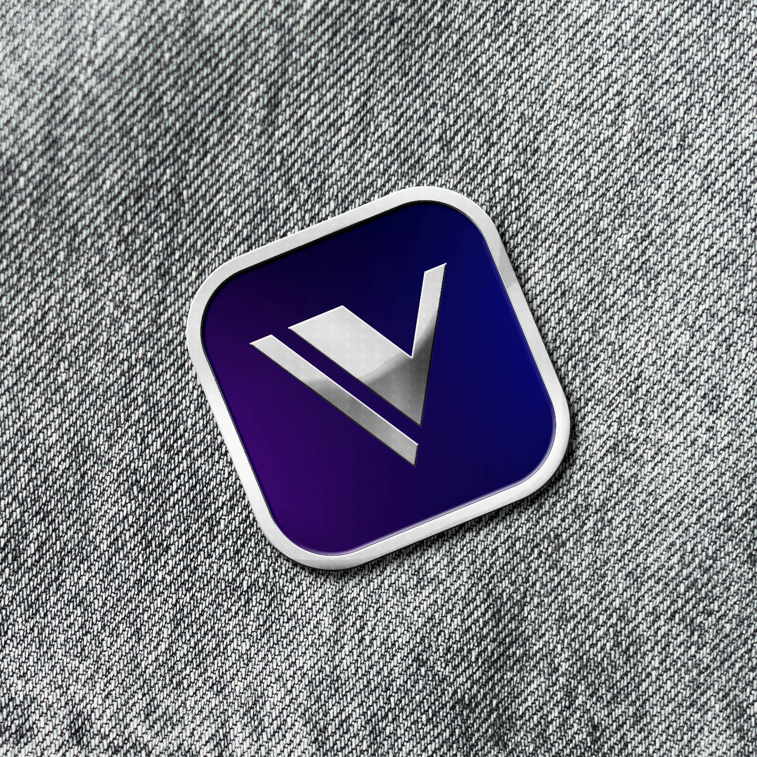 Denim jacket displaying an enamel pin of the Vala app icon