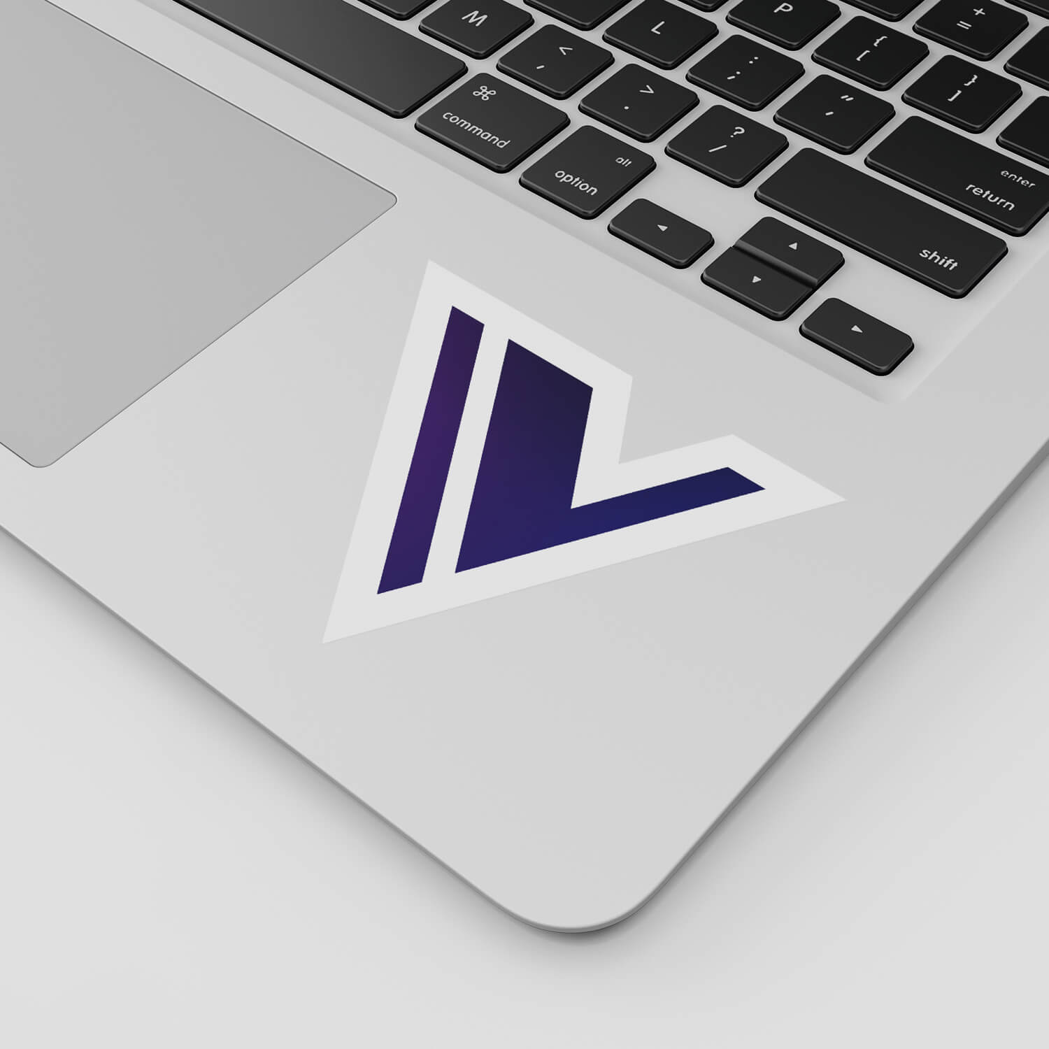 Close-up shot of a laptop with a sticker of the Vala app icon