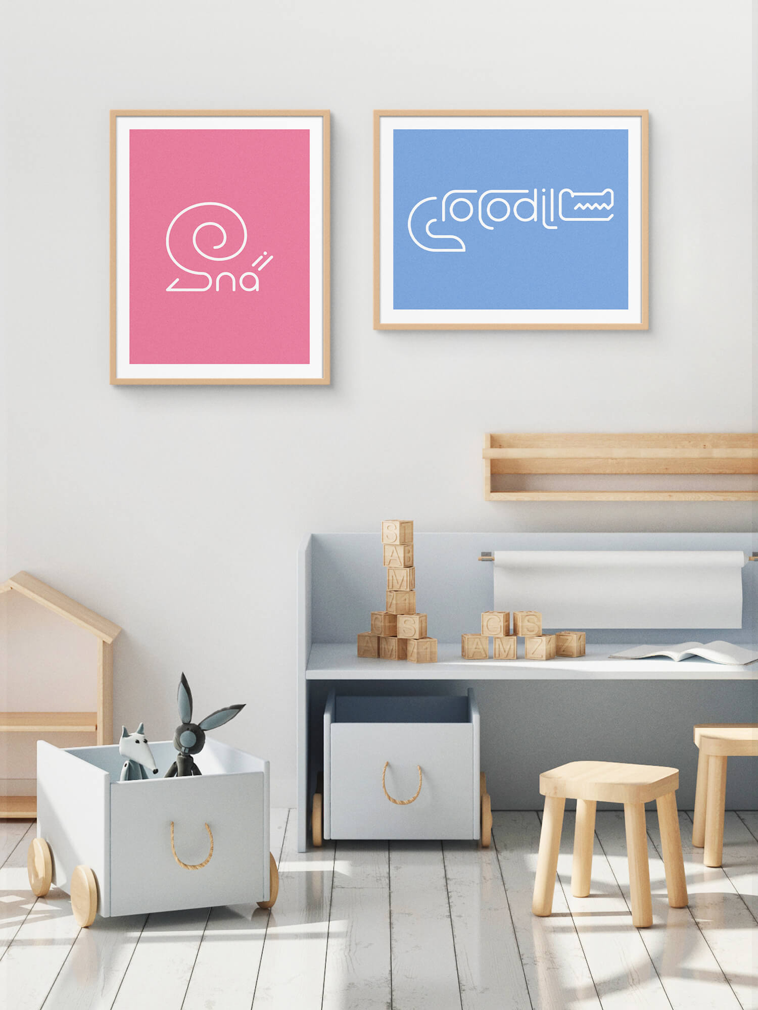 Two framed Word Animals prints displaying the illustration of a snail and crocodile on the wall of a childs room