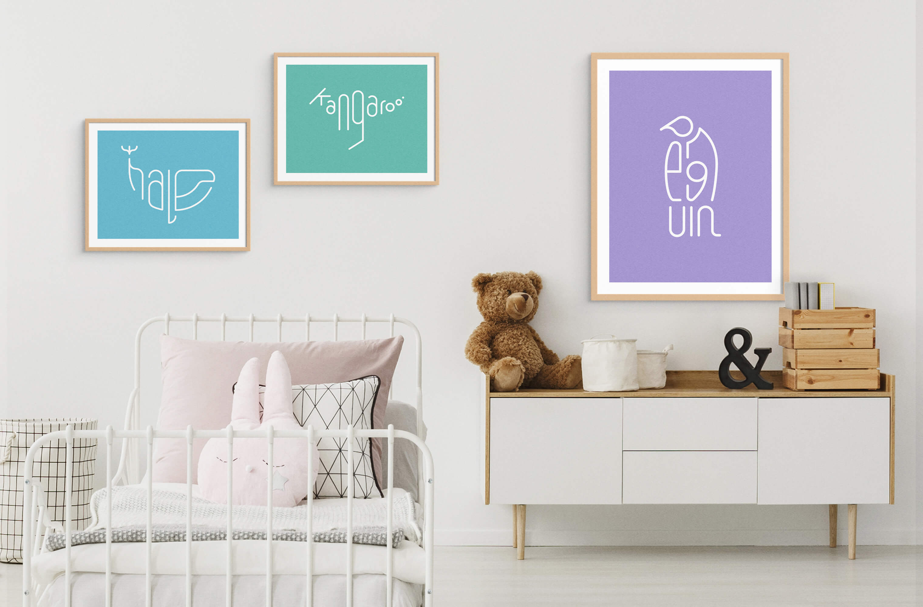 Three framed Word Animals prints displaying the illustrations of a whale, kangaroo and penguin on the wall of a childs room