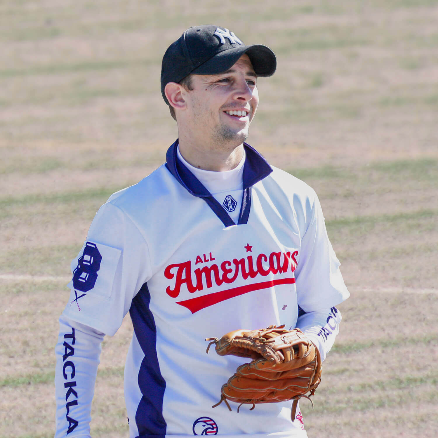 An All Americans player in uniform holding a glove on the field