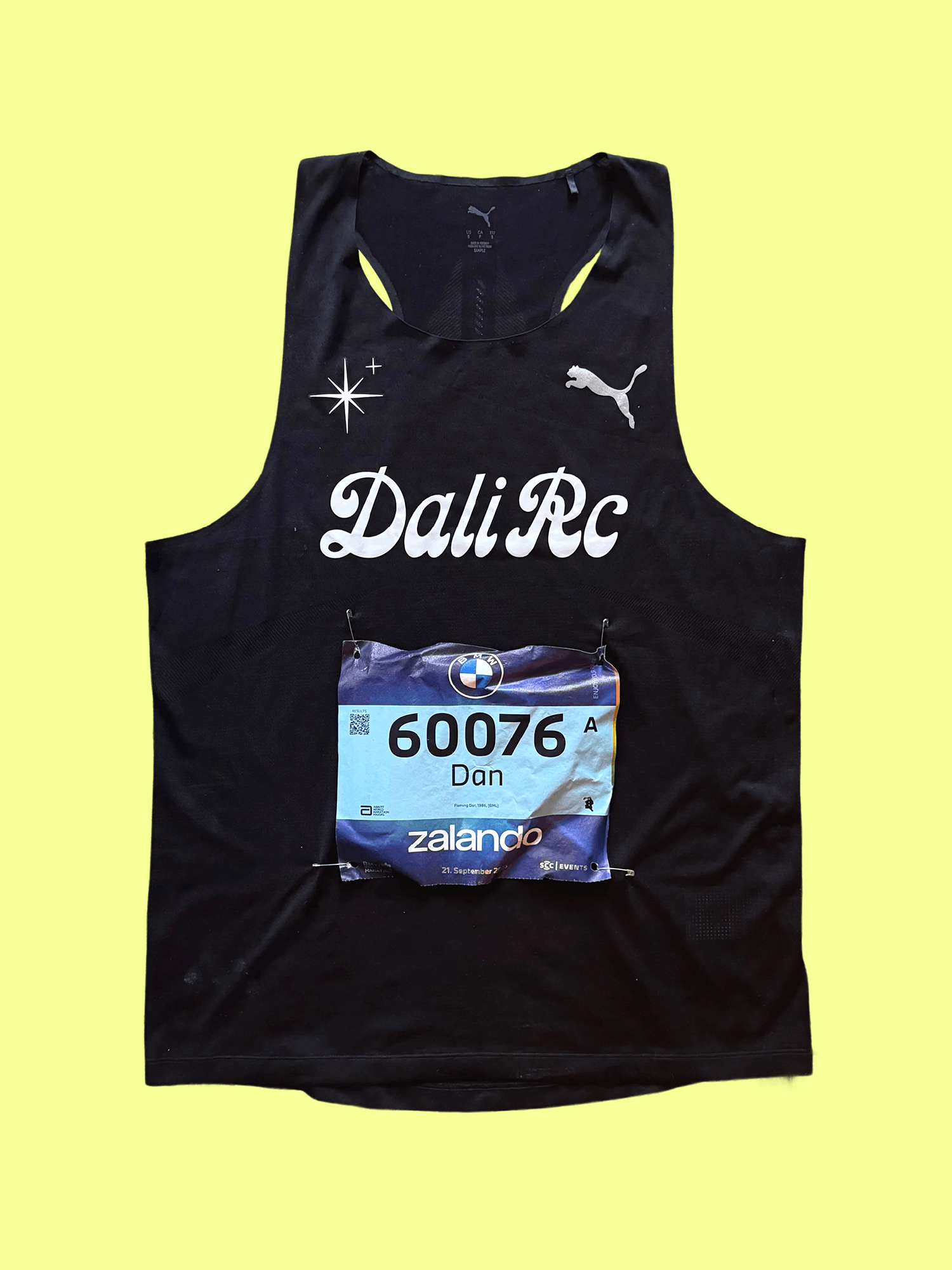 Black DALI RC race singlet with a Berlin Marathon bib on a yellow background