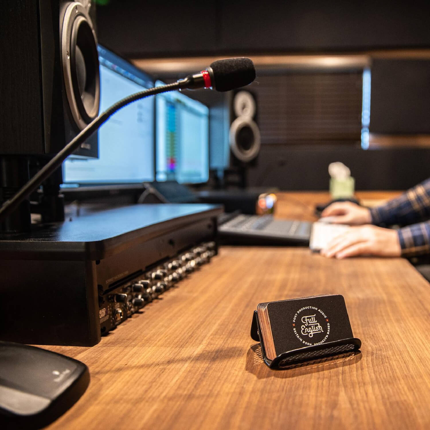Full English business cards in a holder on a studio mixing desk