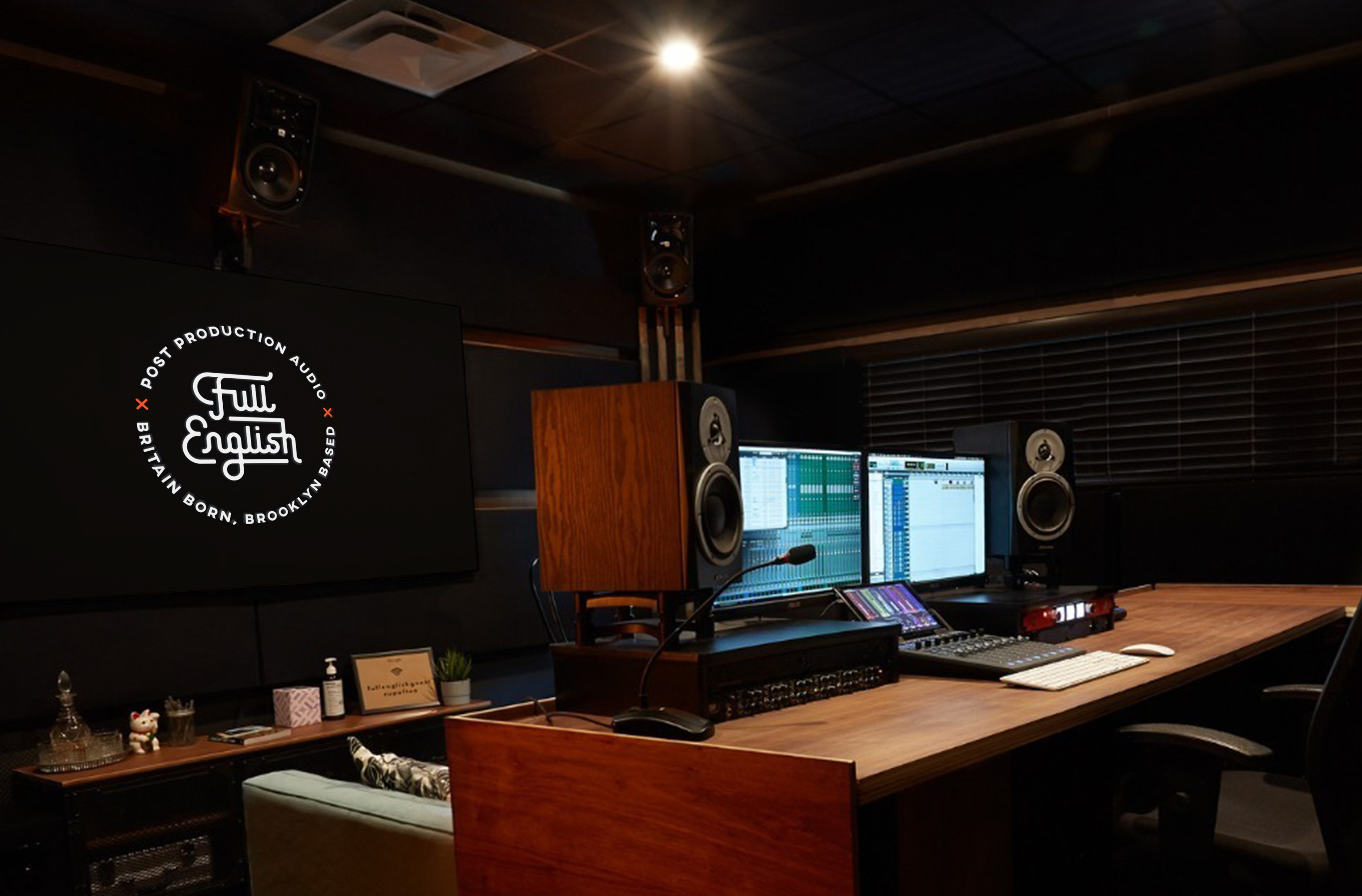 The Full English badge on a monitor in a post-production audio control room with studio monitors and a mixing desk