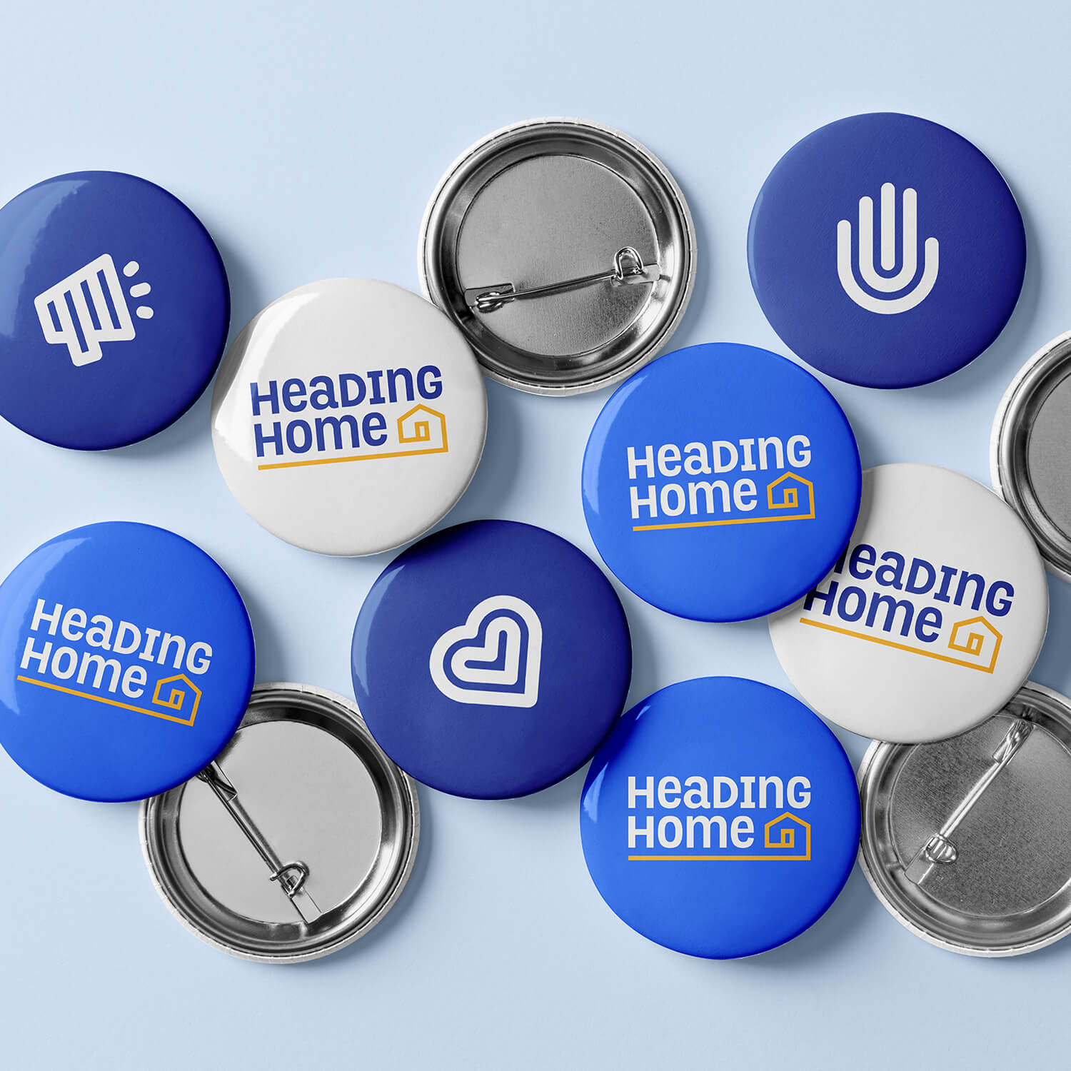 Heading Home pin buttons in blue and white on a light blue background