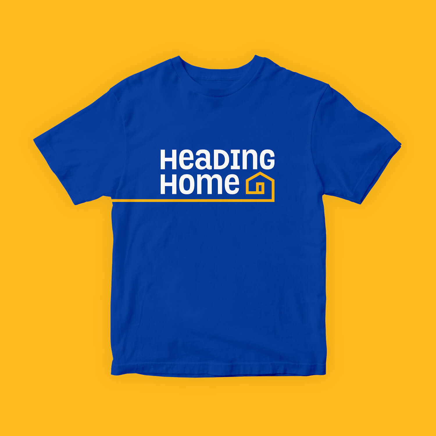 A blue Heading Home t-shirt on a yellow background