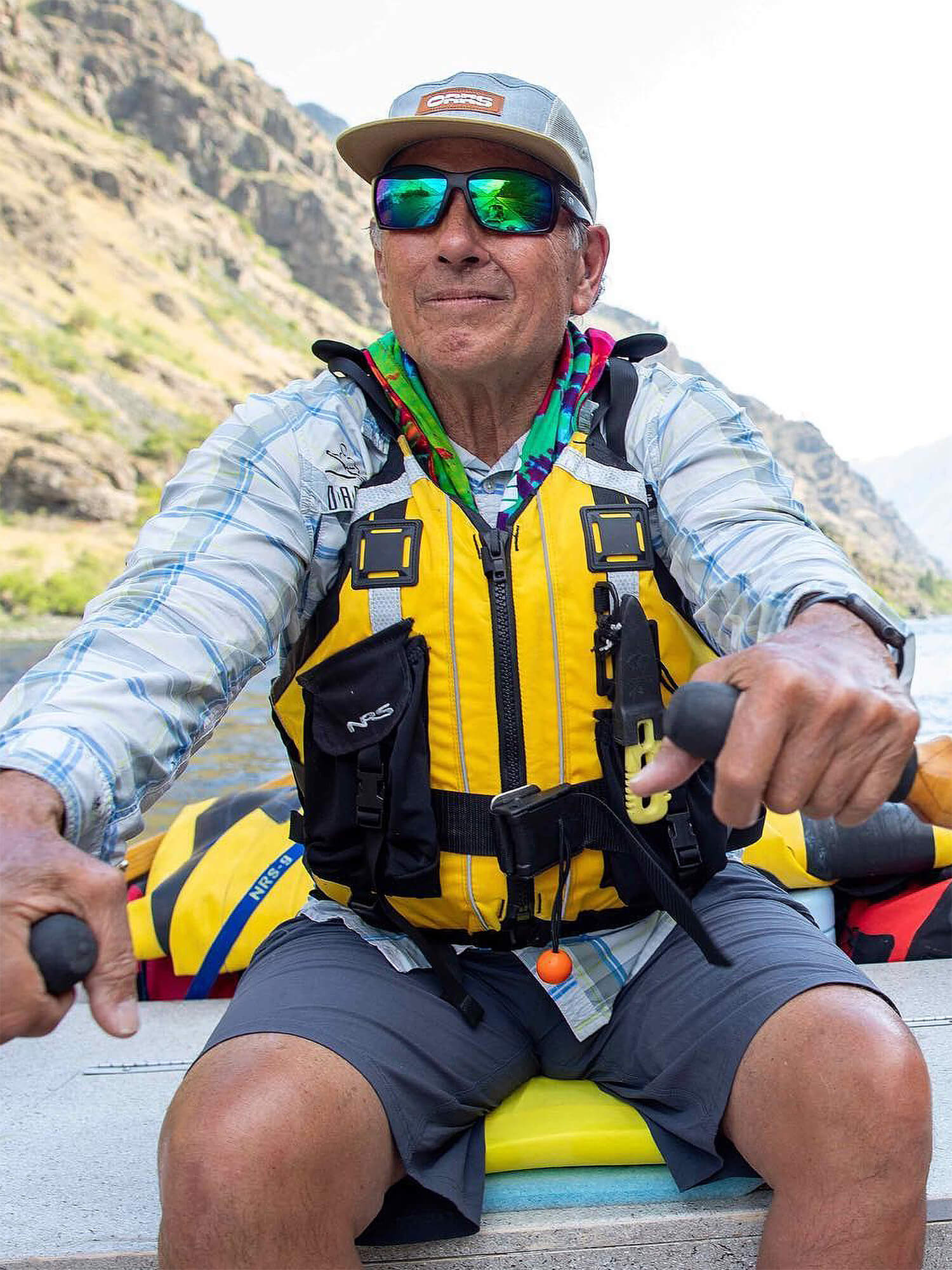 A veteran OARS guide rowing a raft down the river